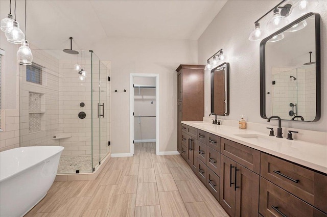 full bathroom with a stall shower, a freestanding tub, a sink, and double vanity