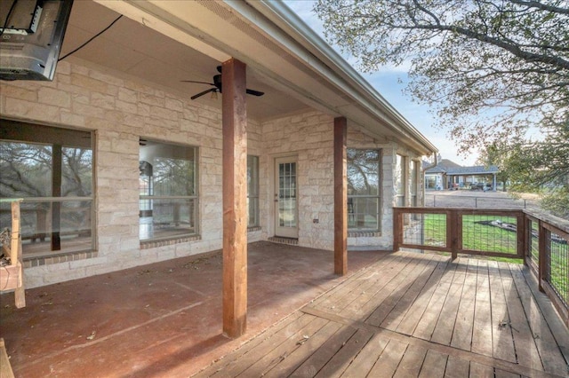 wooden deck with a ceiling fan