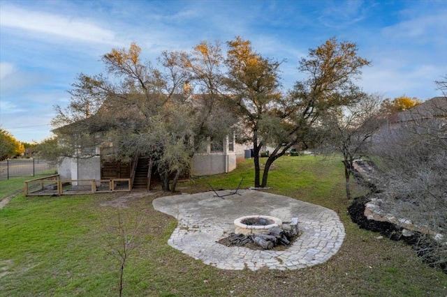 view of yard featuring fence, a fire pit, and a patio