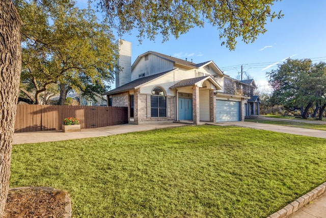 view of front of home featuring a chimney, concrete driveway, a front yard, fence, and a garage