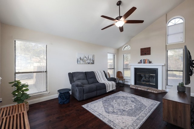 living area with high vaulted ceiling, a brick fireplace, baseboards, and dark wood-type flooring