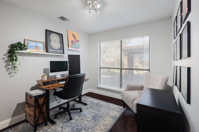 home office featuring visible vents, baseboards, and wood finished floors