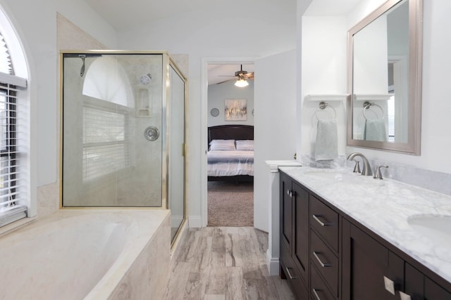 full bathroom with double vanity, lofted ceiling, a sink, a shower stall, and a bath