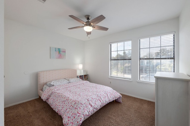 carpeted bedroom with a ceiling fan and baseboards