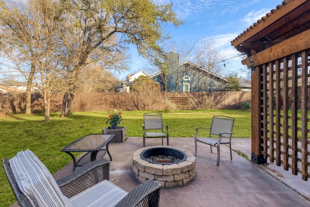 view of patio with fence private yard and a fire pit