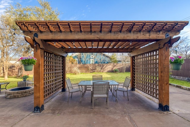 view of patio with a fenced backyard, a fire pit, outdoor dining area, and a pergola