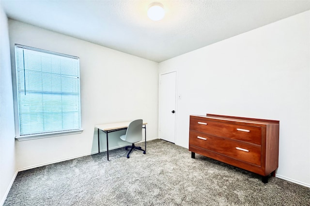 carpeted home office featuring baseboards