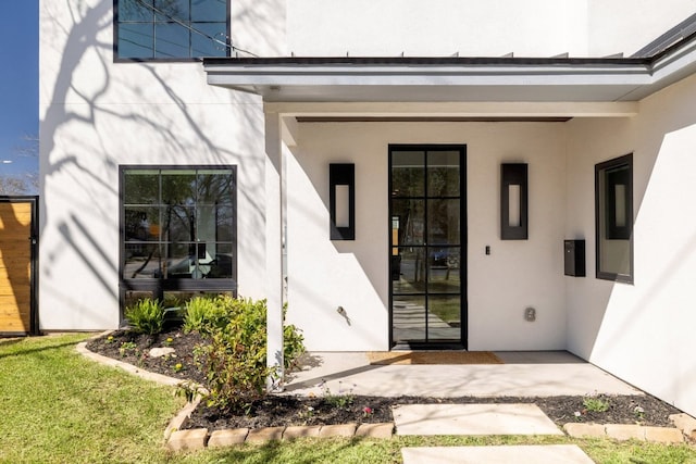 doorway to property with stucco siding