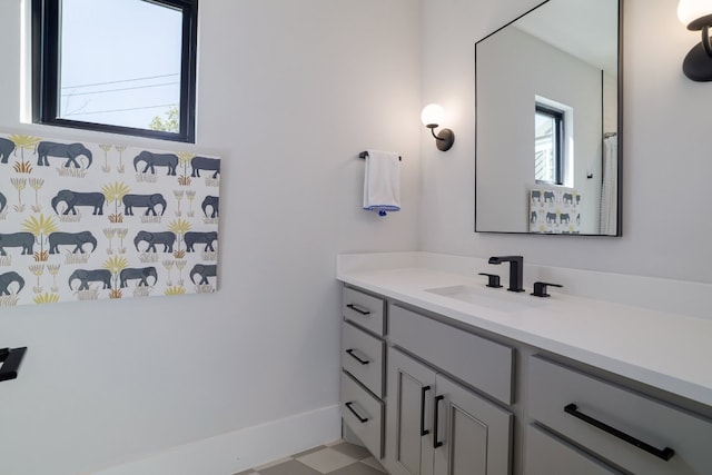 bathroom with vanity and baseboards