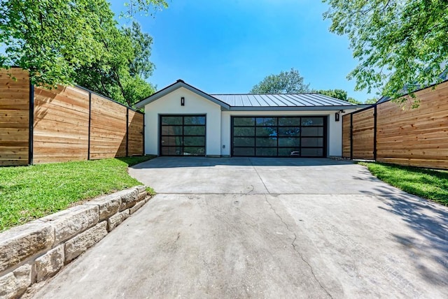 garage featuring driveway and fence