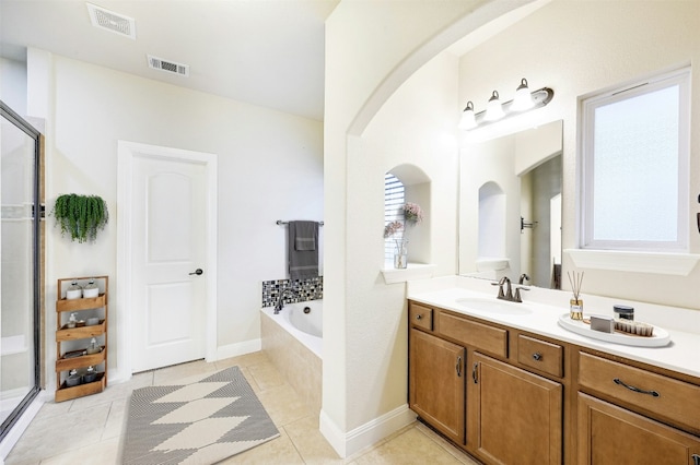 bathroom with visible vents, vanity, a shower stall, and a bath