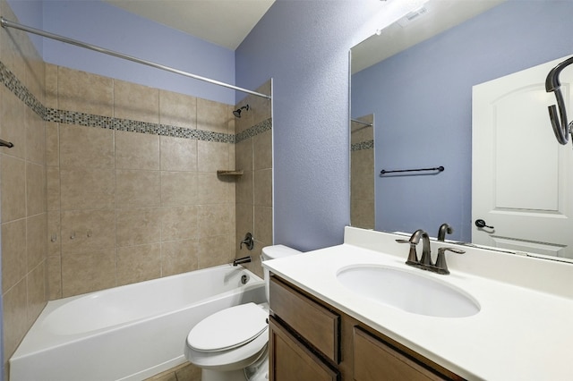 full bath with a textured wall, shower / tub combination, toilet, visible vents, and vanity