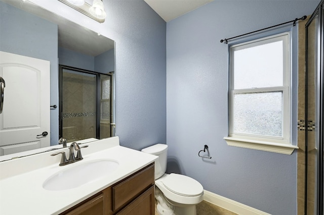 full bath featuring a textured wall, toilet, a stall shower, vanity, and baseboards