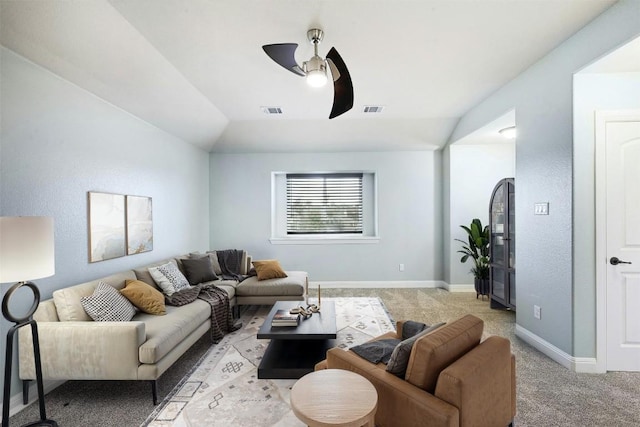 living room featuring ceiling fan, lofted ceiling, visible vents, and light colored carpet