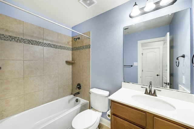 full bathroom with a textured wall, toilet, shower / bath combination, vanity, and visible vents