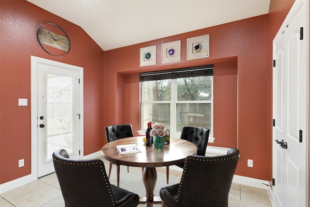 dining room featuring baseboards and light tile patterned floors