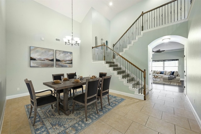 tiled dining space with stairway, baseboards, and an inviting chandelier