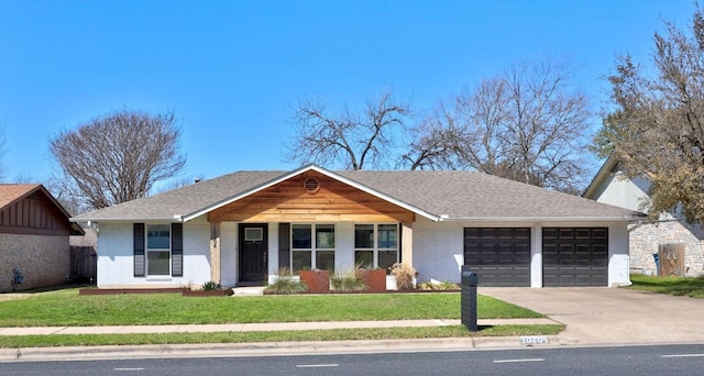 single story home with a garage, concrete driveway, brick siding, and a front lawn