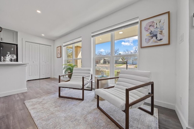 sitting room with recessed lighting, wood finished floors, and baseboards