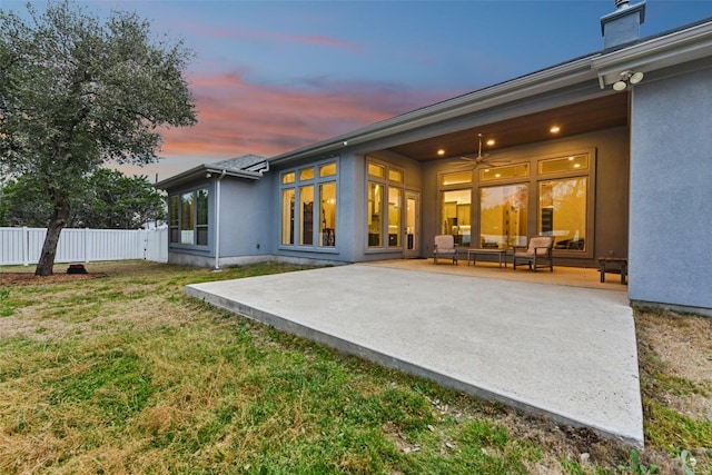 back of house featuring a yard, a patio, stucco siding, ceiling fan, and fence