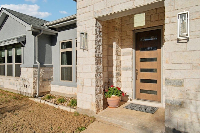 doorway to property featuring stone siding