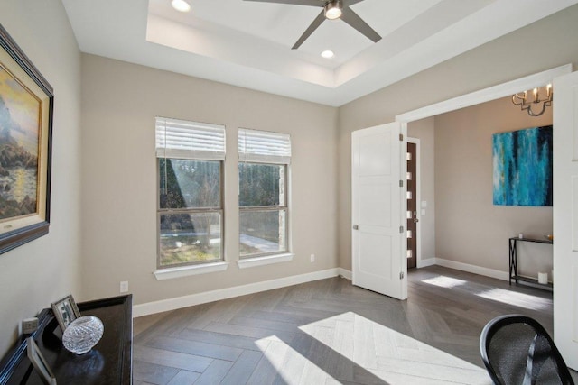 office area with ceiling fan with notable chandelier, baseboards, a raised ceiling, and recessed lighting