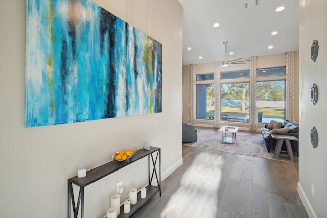 hallway with baseboards, visible vents, wood finished floors, and recessed lighting