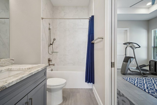 full bath featuring shower / bath combo, vanity, toilet, and wood finished floors