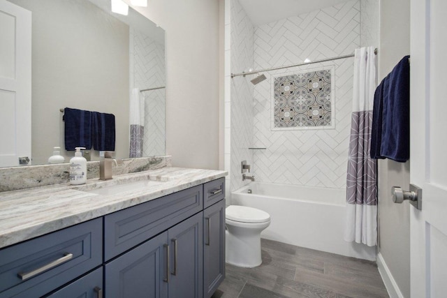 bathroom featuring toilet, shower / bath combo with shower curtain, wood finished floors, and vanity