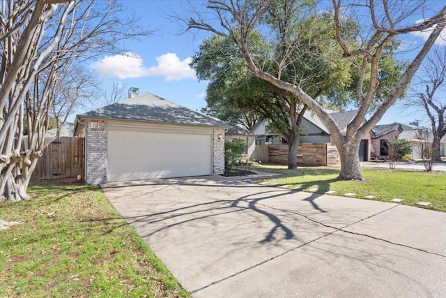 view of front of home featuring a garage, an outbuilding, fence, a front lawn, and brick siding