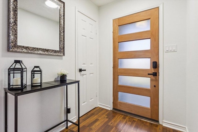 entrance foyer with dark wood-style floors and baseboards