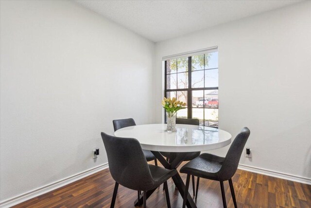 dining room featuring wood finished floors and baseboards