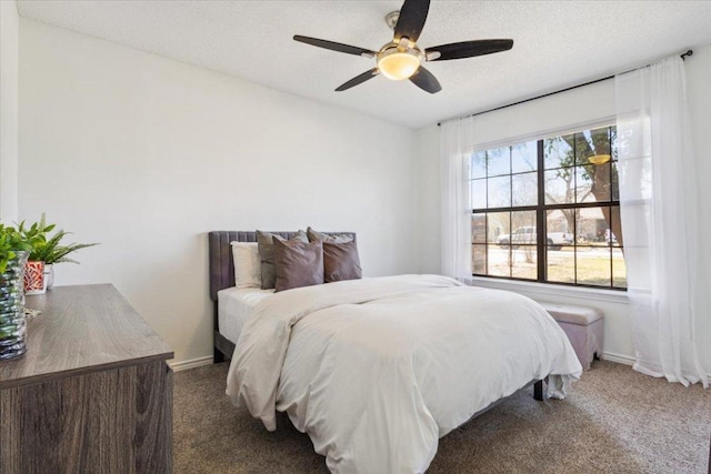 bedroom featuring carpet floors, ceiling fan, baseboards, and a textured ceiling