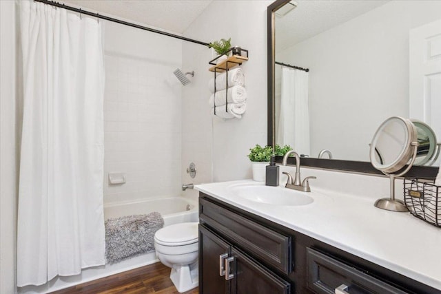 bathroom featuring shower / tub combo with curtain, toilet, a textured ceiling, vanity, and wood finished floors