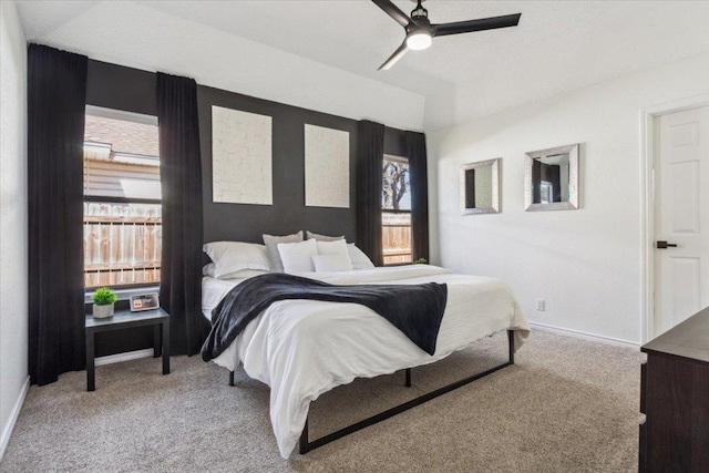 carpeted bedroom featuring ceiling fan and baseboards