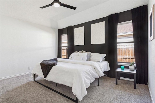 bedroom with ceiling fan, carpet, and baseboards