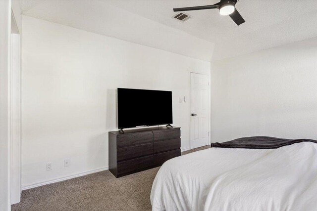 carpeted bedroom with ceiling fan, visible vents, and baseboards