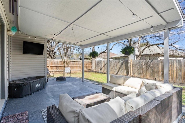 view of patio / terrace with an outdoor living space with a fire pit and a fenced backyard