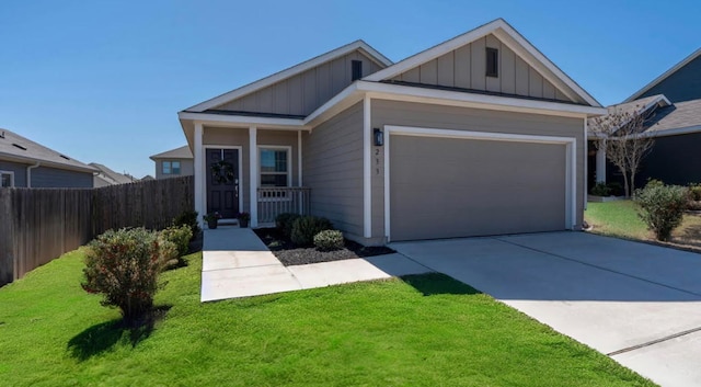 view of front facade featuring an attached garage, board and batten siding, a front yard, fence, and driveway