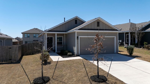 view of front facade featuring driveway, board and batten siding, an attached garage, and fence