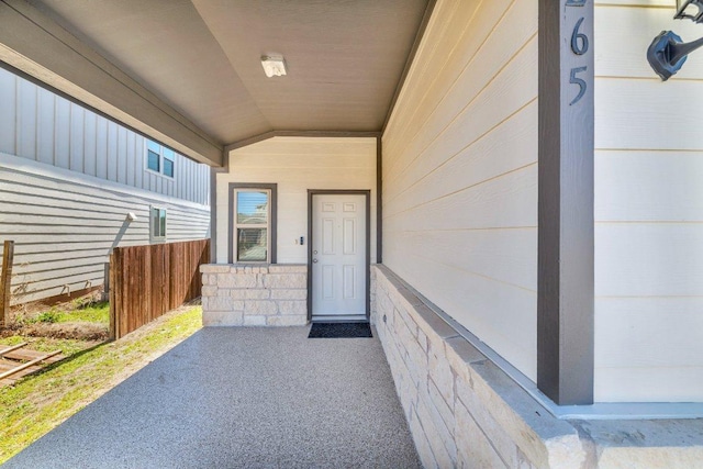 doorway to property featuring fence