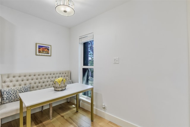 dining room with baseboards, breakfast area, and wood finished floors