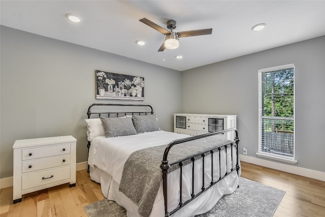 bedroom featuring a ceiling fan, light wood-type flooring, baseboards, and recessed lighting