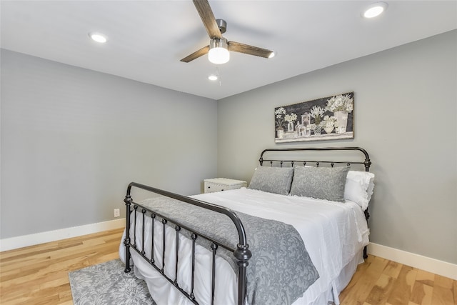 bedroom with recessed lighting, baseboards, and wood finished floors