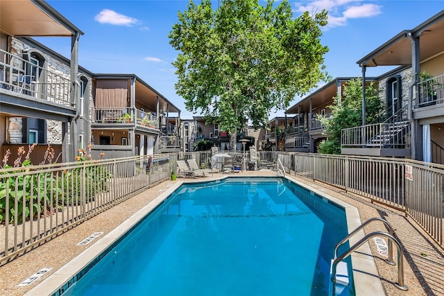 pool featuring fence and a residential view