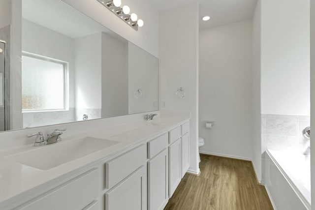 6500 Cetone Ter, Round Rock, TX 78665 - full bath featuring toilet, a bath, double vanity, wood finished floors, and an enclosed shower