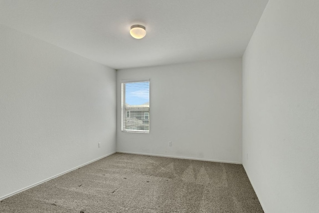 empty room with carpet flooring and baseboards