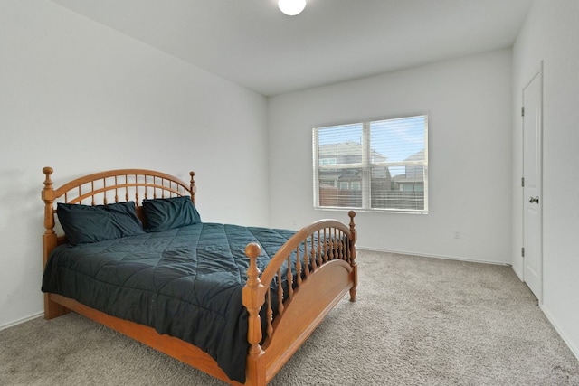 carpeted bedroom featuring baseboards