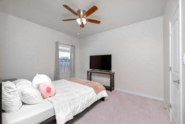 bedroom featuring light carpet, ceiling fan, and baseboards