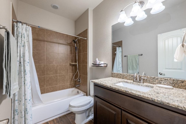 full bath featuring toilet, an inviting chandelier, shower / bath combo, vanity, and wood finished floors